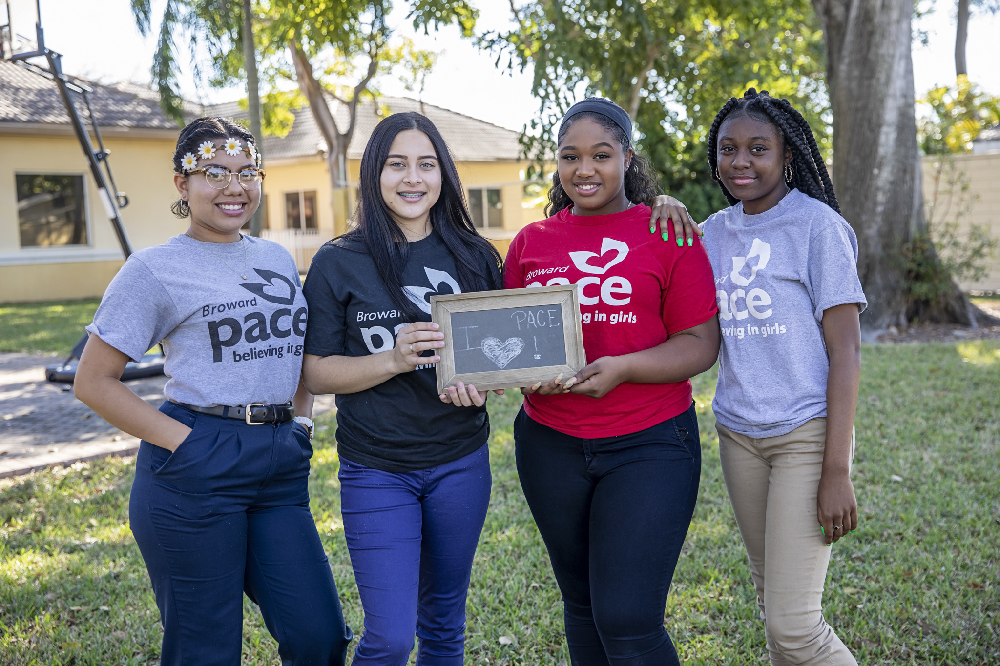 Four teen girls in pace t-shirts holding an "I love pace" sign